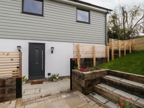 a house with a fence and a yard at Sevenwoods View in Longhope