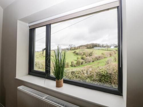 a window with a view of a green field at Sevenwoods View in Longhope