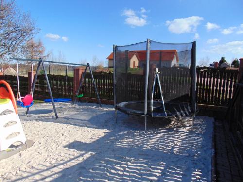 a group of swings in a playground at Słoneczny dom w górach, Sauna, basen Karpacz Opawa in Lubawka