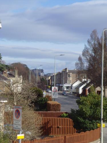 a street in a town with a fence and street signs at Twin Lions Hotel in Edinburgh