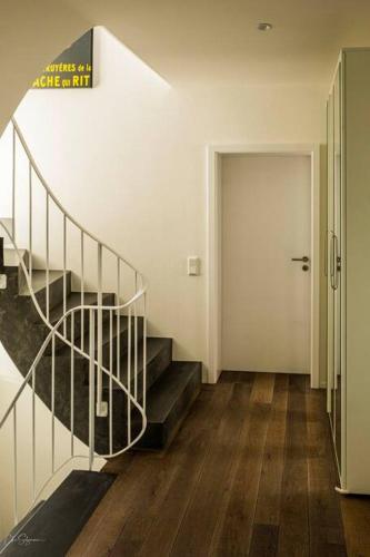 a hallway with a staircase and a white door at Panoramahaus am Schlipfweg in Weil am Rhein