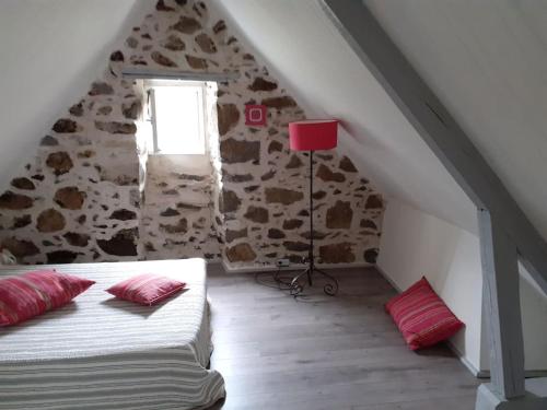 a bedroom with a bed and a red lamp at Les 2 p'tits loups in Osse-en-Aspe