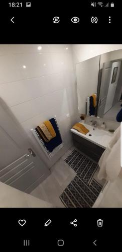 une salle de bain avec un lavabo et un miroir dans l'établissement Confortable Apt 10 min des plages, au Cannet