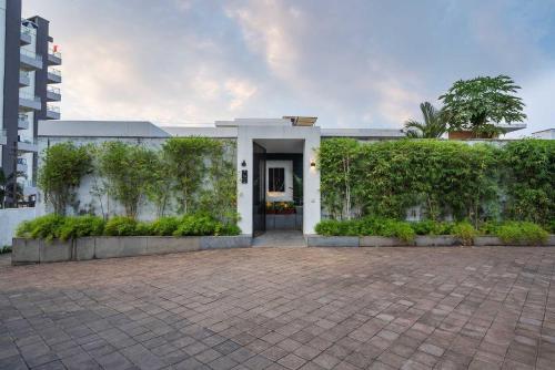 a white house with a courtyard in front of it at Isle View by VEO - Part of StayVista in Dabolim