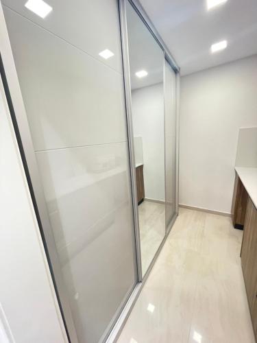 a glass walk in shower in a room at Milan suit in Or Yehuda