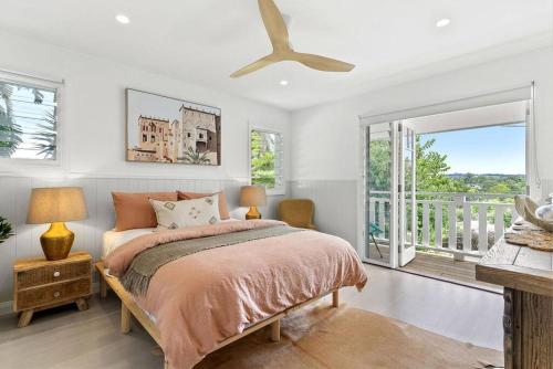 a bedroom with a bed and a balcony at Bangalla in Bangalow