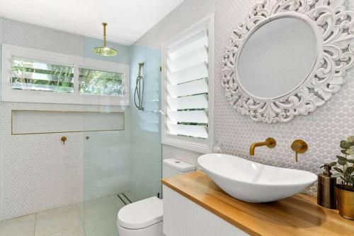 a bathroom with a white sink and a mirror at Bangalla in Bangalow