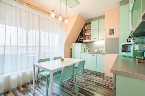 a kitchen with a table and chairs and a window at Zen Home pLOVEdiv in Plovdiv