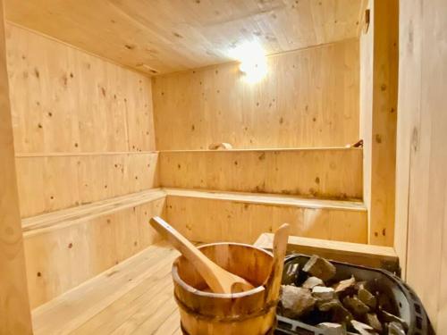 a wooden sauna with a bucket in the middle at Bali Residence I B3105 Luxury 2BR I Seaview I 6-9pax l WaterPark I CityCentre by Jay Stay in Melaka