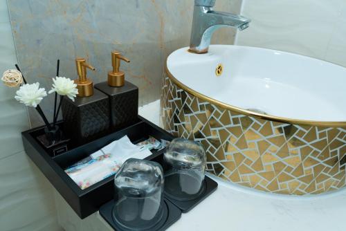 a bathroom with a sink and a counter with a sink at Queen Central Hotel - Ben Thanh Market in Ho Chi Minh City