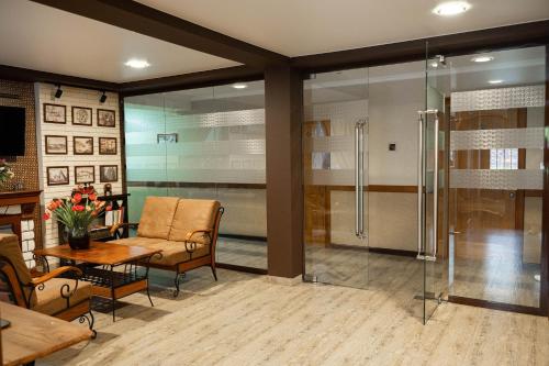a living room with a glass shower and a table at UYUTNYY DOM in Taraz