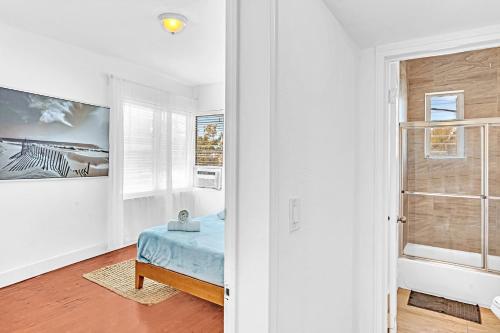 a bedroom with a blue bed and a window at Garden Suite 3-Hosted by Sweetstay in Miami Beach