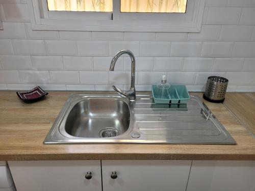 a stainless steel kitchen sink with a faucet at La Playita Santa María Beach in Cádiz
