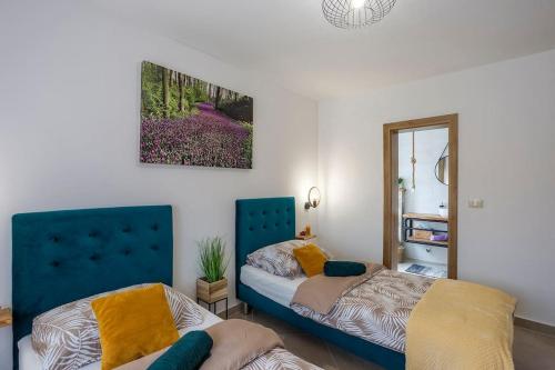 a bedroom with two beds and a mirror at House with pool Poli Stare nuoni in Žminj