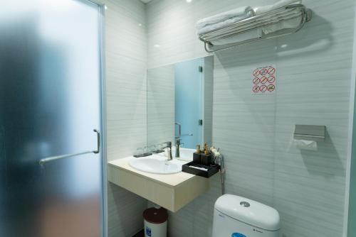 a bathroom with a sink and a toilet and a mirror at Queen Central Hotel - Ben Thanh Market in Ho Chi Minh City