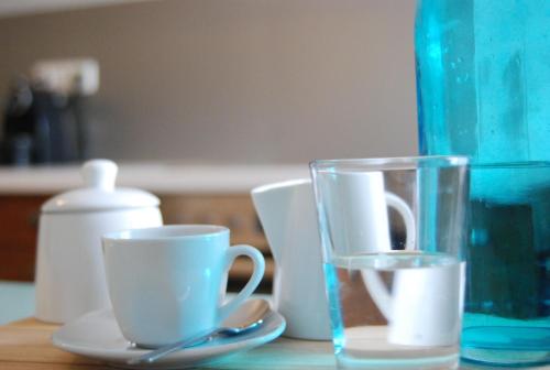a table with two cups and a glass on it at Gästewohnung Ida in Oberwart