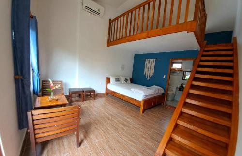 a room with a bed and a staircase with a stair case at Ong Lang Bay Resort in Phú Quốc
