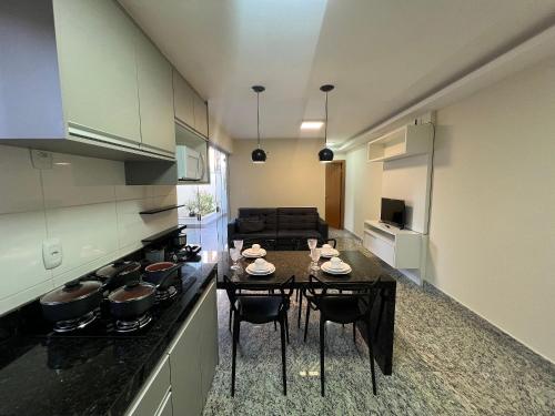 a kitchen with a table and some pots and pans at LK Savassi 5 in Belo Horizonte