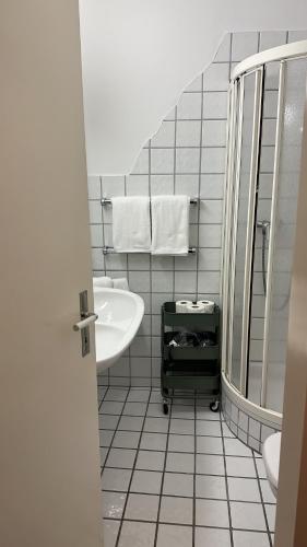 a white bathroom with a sink and a mirror at Appartamento Ascona Vista Lago in Ascona