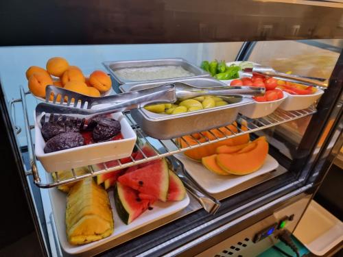 a refrigerator filled with lots of fruits and vegetables at Hotel Orchidea in Lignano Sabbiadoro