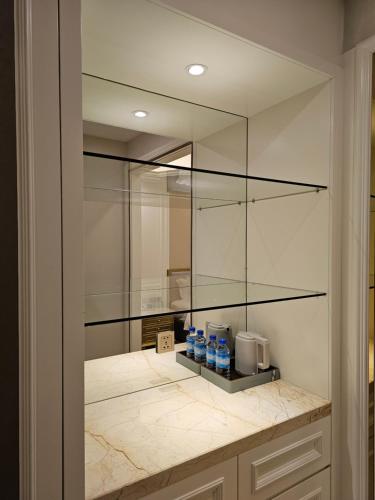 a bathroom with two bottles of water and a mirror at Swan Lake Hotel in Tourakom