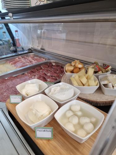 a display of different types of food in a refrigerator at Hotel Orchidea in Lignano Sabbiadoro