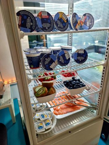 a refrigerator filled with lots of different types of food at Hotel Orchidea in Lignano Sabbiadoro