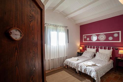 a bedroom with purple walls and a bed and a window at Villa San Regolino whit private pool in Radicondoli