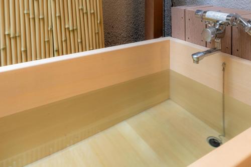 a sink in a bathroom with a faucet at Hotel Isago Kobe in Kobe