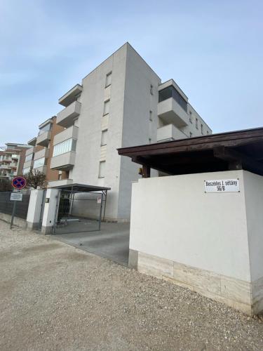 a building with a sign on the side of it at Solar Villa Apartmanok By BLTN in Siófok