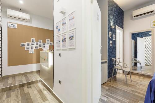 a room with a refrigerator and a table and a chair at Scaramantico Rooms in Naples