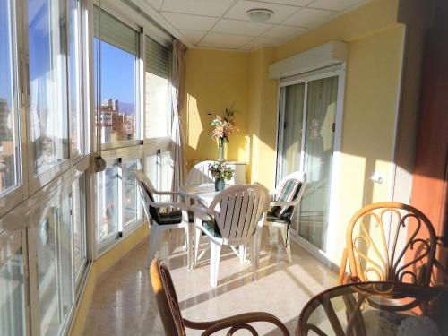a dining room with a table and chairs on a balcony at Ola Azul Sea View Apartment in Benidorm