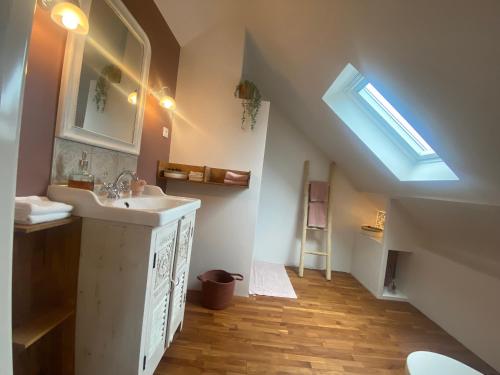 a bathroom with a sink and a skylight at Douce Halte in Sautron
