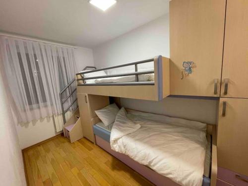 a small room with a bunk bed in it at Arian's Apartment in Pristina