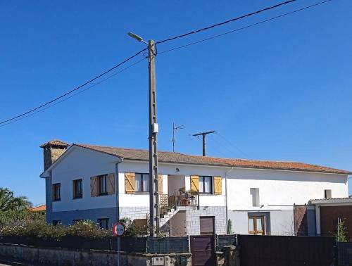 a white house with a street light in front of it at Casa María VUT 5614 AS in Villaviciosa