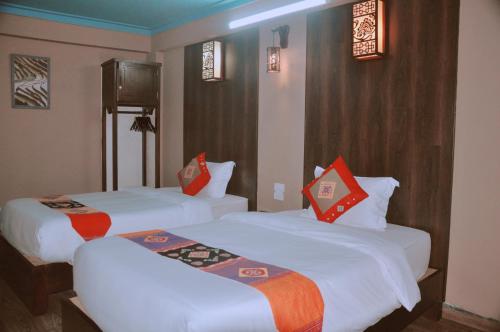 a hotel room with two beds with red pillows at Sapa Hills Hotel in Sa Pa