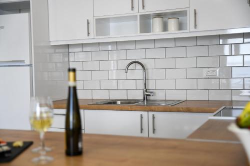 a kitchen with a sink and a bottle of wine at Villa Veranda Agios NIkolaos (suite) in Agios Nikolaos