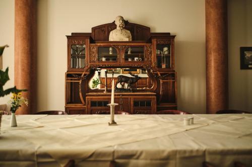 a table in a room with a statue in the background at Hotel Exel in Amstetten