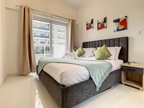 a bedroom with a large bed with a window at Key View Hera Tower in Dubai