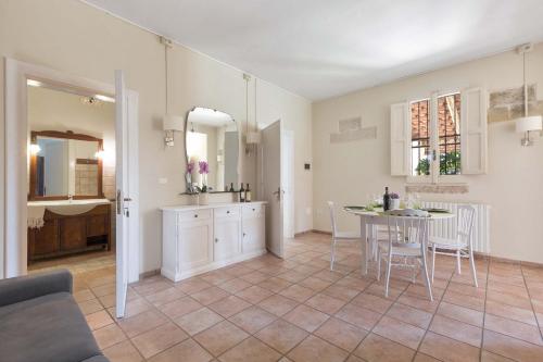 una cucina e una sala da pranzo con tavolo e sedie di Dependance di Omero by BarbarHouse a Cavallino di Lecce