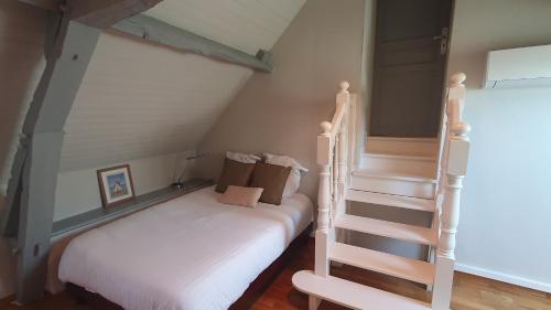 a bedroom with a bed and a stair case at Villa du Bonheur - 10 pers. - Spa - Sauna - Hammam 