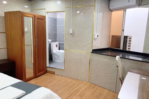 a bedroom with a bathroom with a toilet and a sink at Saigon Hub Hostel in Ho Chi Minh City