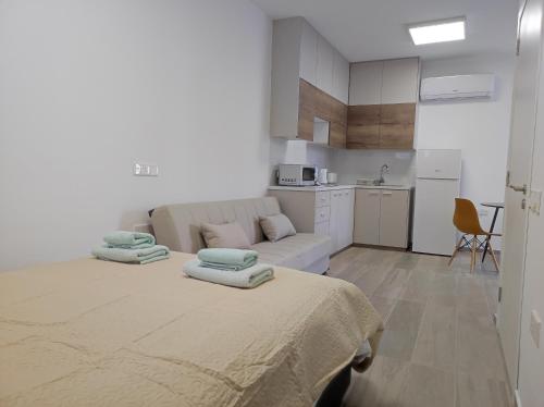 a living room with a bed and a kitchen at St. Lazaros Studios 2 in Larnaka