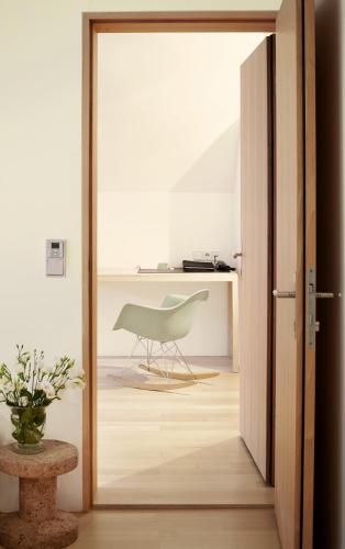 a door leading into a room with a chair at Hotel Post Bezau in Bezau