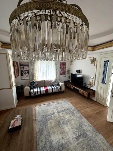 a large chandelier in a living room with a couch at Luxury Detached Villa in Kilyos in Sarıyer