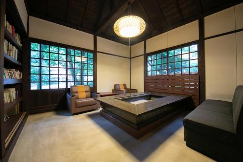 a living room with a couch and a coffee table at Hosenji Kanko Hotel Yumotoya in Kokonoe