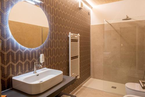 a bathroom with a sink and a mirror at Relais Limonaia - Suites & Garden SPA in Torri del Benaco