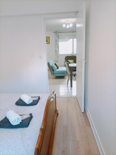 a bedroom with a bed and a living room at FELTON - Appartement 2 pers Dinan in Dinan