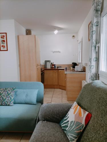 a living room with a couch and a kitchen at FELTON - Appartement 2 pers Dinan in Dinan