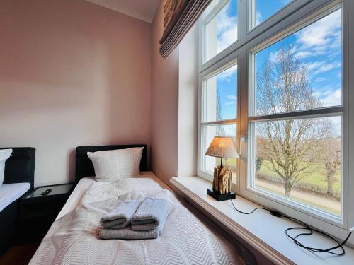 um quarto com uma cama ao lado de uma janela em Putbus Ferienwohnung Kleine Auszeit em Putbus